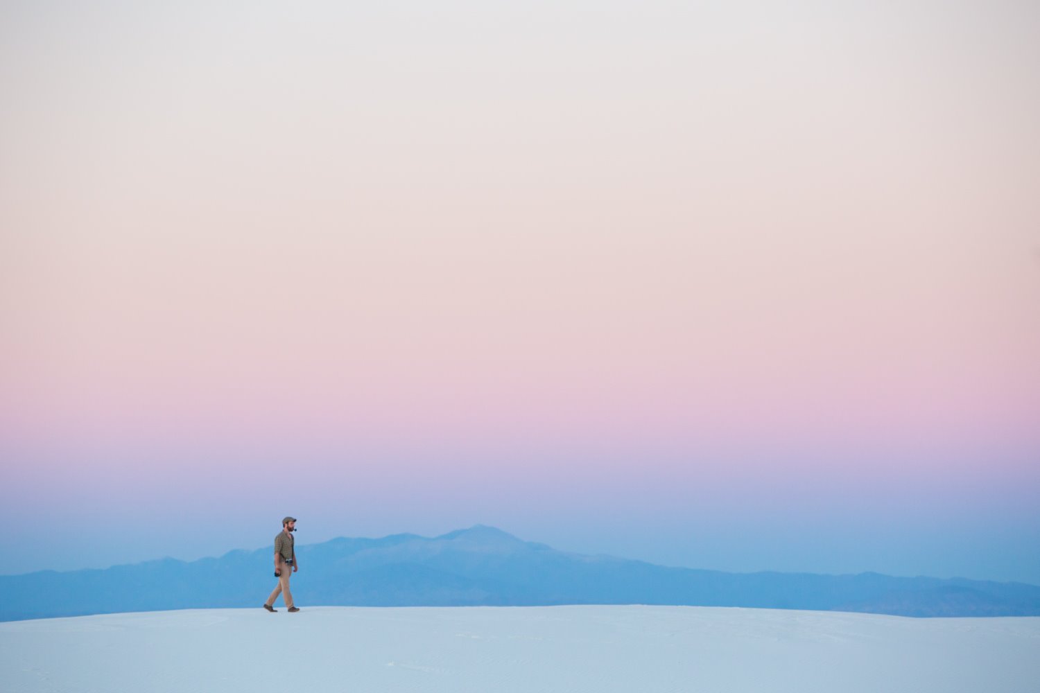 man walking in minimalistic landscape photography composition